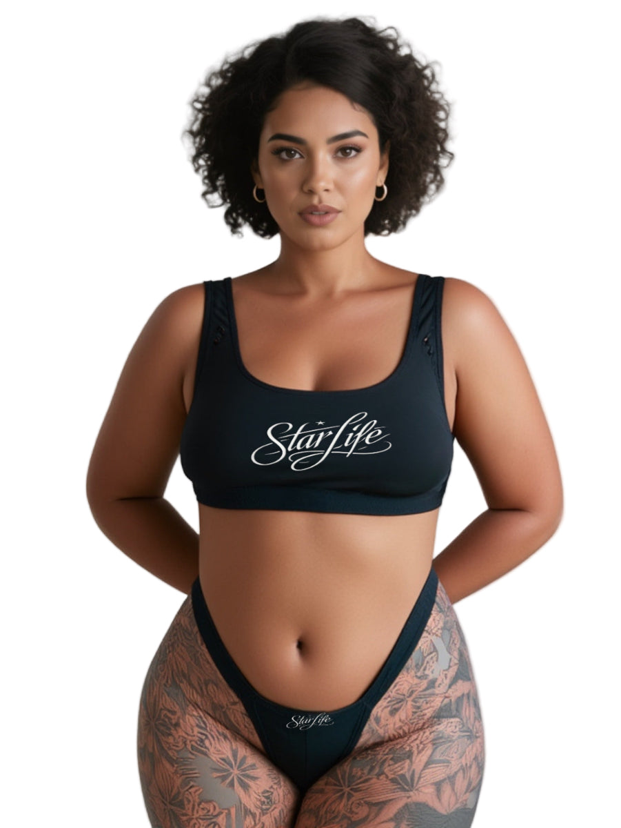 Woman wearing a black 'StarLife' sports top on a white background